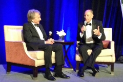 In a format popularized by RRDC President Bobby Rahal, host Derek Bell interviews 2016 Honoree Hans Stuck (right).