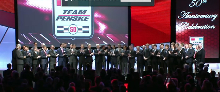 Roger Penske is flanked by 42 of his drivers - past and present. [UTube screen grab]